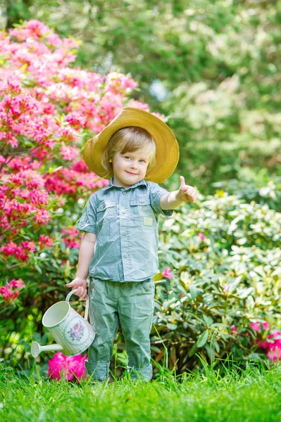 Little gardener in the blooming trees — Stock Photo, Image