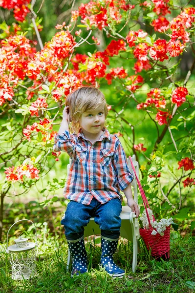 Young gardener in the spring blossoms — Stock Photo, Image