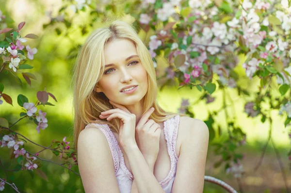 Beautiful spring girl in blooming tree — Stock Photo, Image