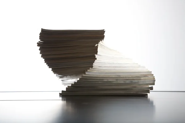 Magazines piled on table — Stock Photo, Image