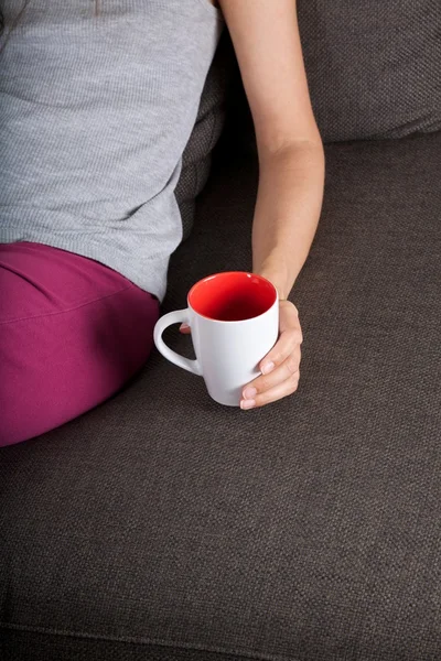 Lying with cup of tea — Stock Photo, Image