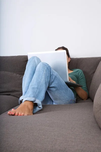 Lying with laptop — Stock Photo, Image