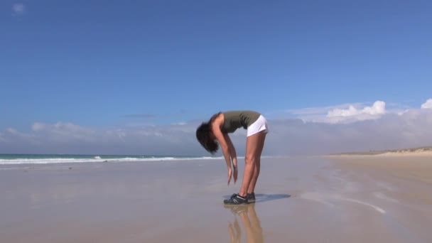 Приваблива жінка займається гімнастикою на пляжі 45 — стокове відео