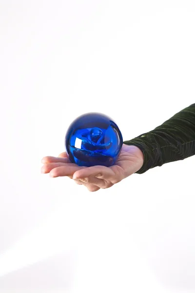 Blue ball on palm — Stock Photo, Image