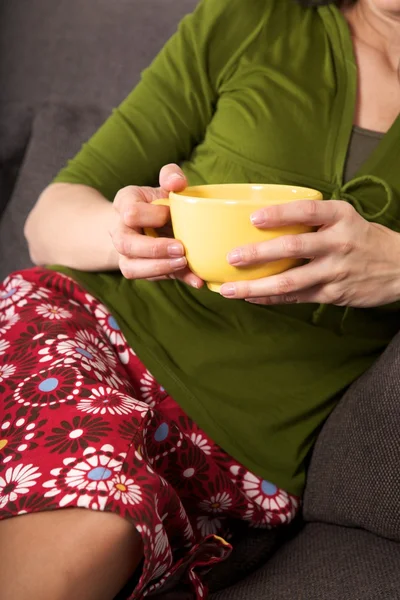 Yellow bowl in woman hands — Stock Photo, Image