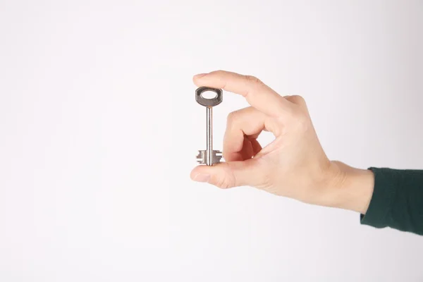 Isolated retro key in woman fingers — Stock Photo, Image