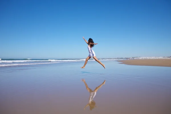 Jumping woman at seashore — Stock Photo, Image