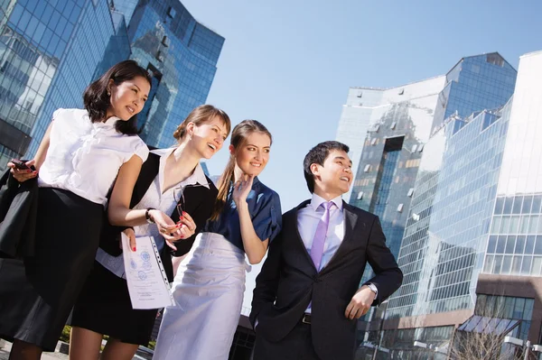Happy diverse group of executives pointing over business center. — Stock Photo, Image