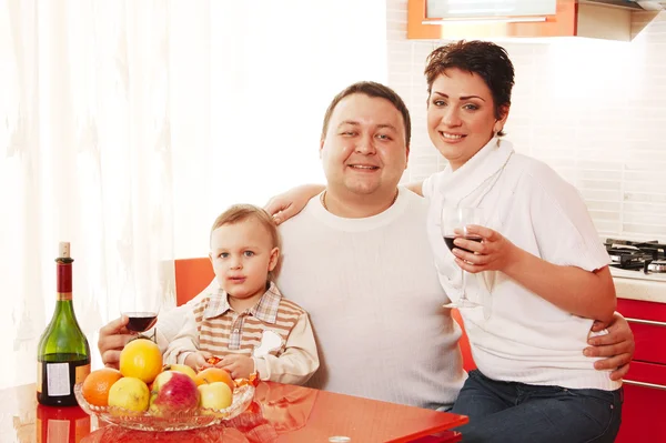 Family in home kitchen drinking wine — Stock Photo, Image