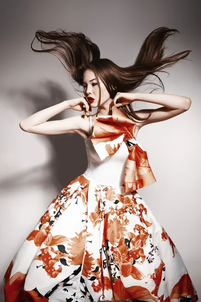 Young beautiful asian brunette in gorgeous Kravets dress, motion shot — 스톡 사진