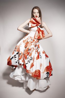 Young beautiful asian brunette in gorgeous Kravets dress. doll