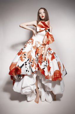 Young beautiful asian brunette in gorgeous Kravets dress. doll