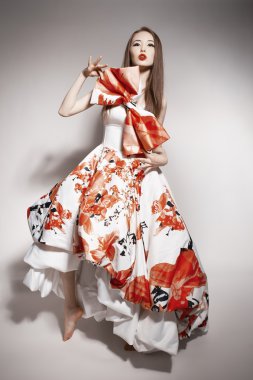 Young beautiful asian brunette in gorgeous Kravets dress. doll