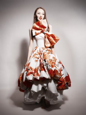 Young beautiful asian brunette in gorgeous Kravets dress
