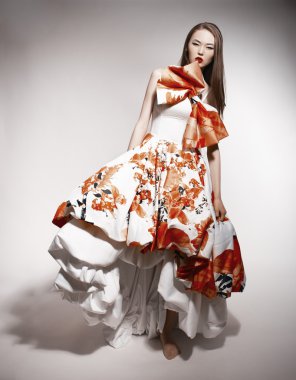 Young beautiful asian brunette in gorgeous Kravets dress