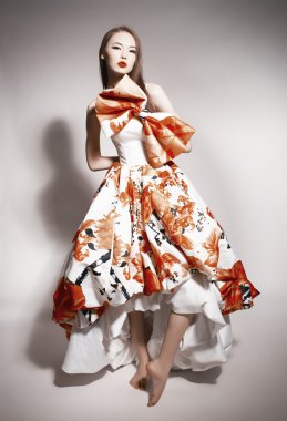 Young beautiful asian brunette in gorgeous Kravets dress