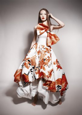 Young beautiful asian brunette in gorgeous Kravets dress