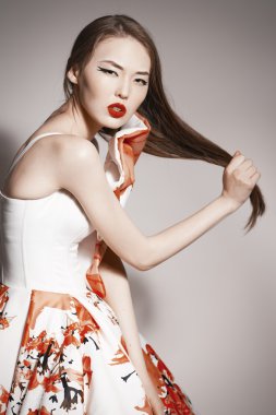 Shocked young beautiful asian brunette in gorgeous Kravets dress.