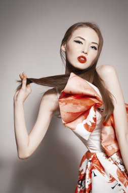 Shocked young beautiful asian brunette in gorgeous Kravets dress.