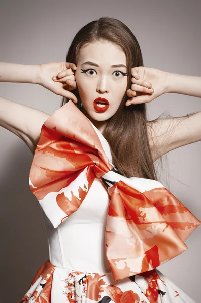 Shocked young beautiful asian brunette in gorgeous Kravets dress. funny — Stock Photo, Image