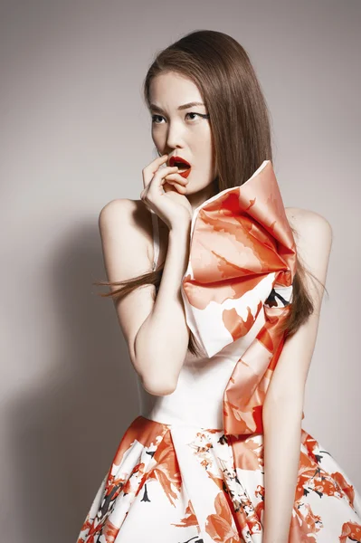 Shocked young beautiful asian brunette in gorgeous Kravets dress. — 스톡 사진