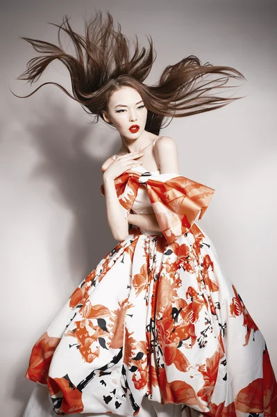 Young beautiful asian brunette in gorgeous Kravets dress, motion shot — Stock Photo, Image