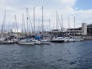 BARCELONA, SPAIN on SEPTEMBER 2019: Port with luxury yachts in european city at Catalonia district, cloudy sky in cold summer day.
