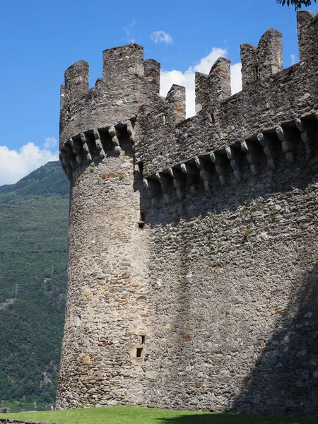 Defense walls of castle in european Bellinzona city, canton Ticino in Switzerland, clear blue sky in 2017 warm sunny summer day on July - vertical