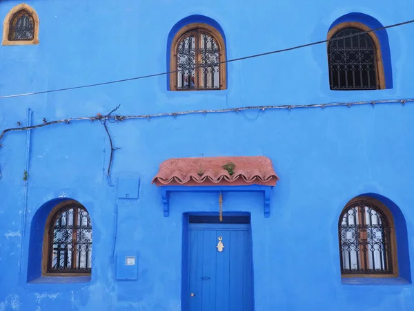 Islamic elevation with eave over door in african Chefchaouen town in Morocco in 2019 warm sunny spring day on April.