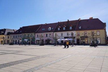 PSZCZYNA, POLAND on MARCH 2022: Colorful houses on market square in european city center, clear blue sky in warm sunny spring day.