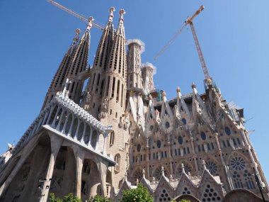 Elevation of cathedral under construction in european Barcelona city at Catalonia n Spain, clear blue sky in 2019 warm sunny summer day on September.