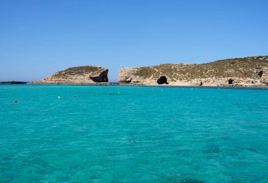 Blue lagoon in european Comino island on Malta, clear blue sky in 2022 warm sunny spring day on May.