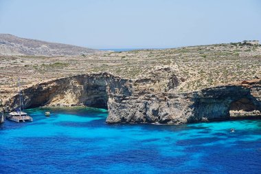 Catamaran on crystal lagoon on european Comino island in Malta