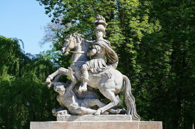 Statue of Sobieski at baths park in Warsaw european capital city of Poland in Masovian, clear blue sky in 2022 warm sunny spring day on May.