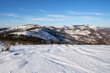 Beautiful Silesian Beskid Mountains view near european Bialy Krzyz in Poland, clear blue sky in 2022 cold sunny winter day on February.
