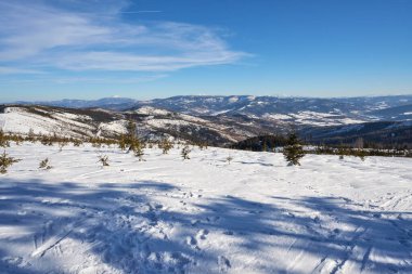 Panoramic Silesian Beskid Mountains view near european Bialy Krzyz in Poland, clear blue sky in 2022 cold sunny winter day on February.