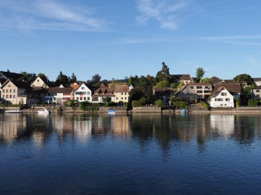 Village at Rhine River in european STEIN AM RHEIN town in SWITZERLAND, canton Schaffhausen, clear blue sky in 2018 warm sunny summer day on August.