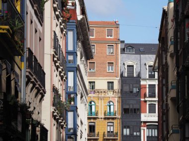 Frontage of colorful buildings in european Bilbao city at Biscay province in Spain, clear blue sky in 2019 warm sunny summer day on September.