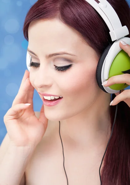 Portrait of a young woman listening to music with headphones Stock Photo