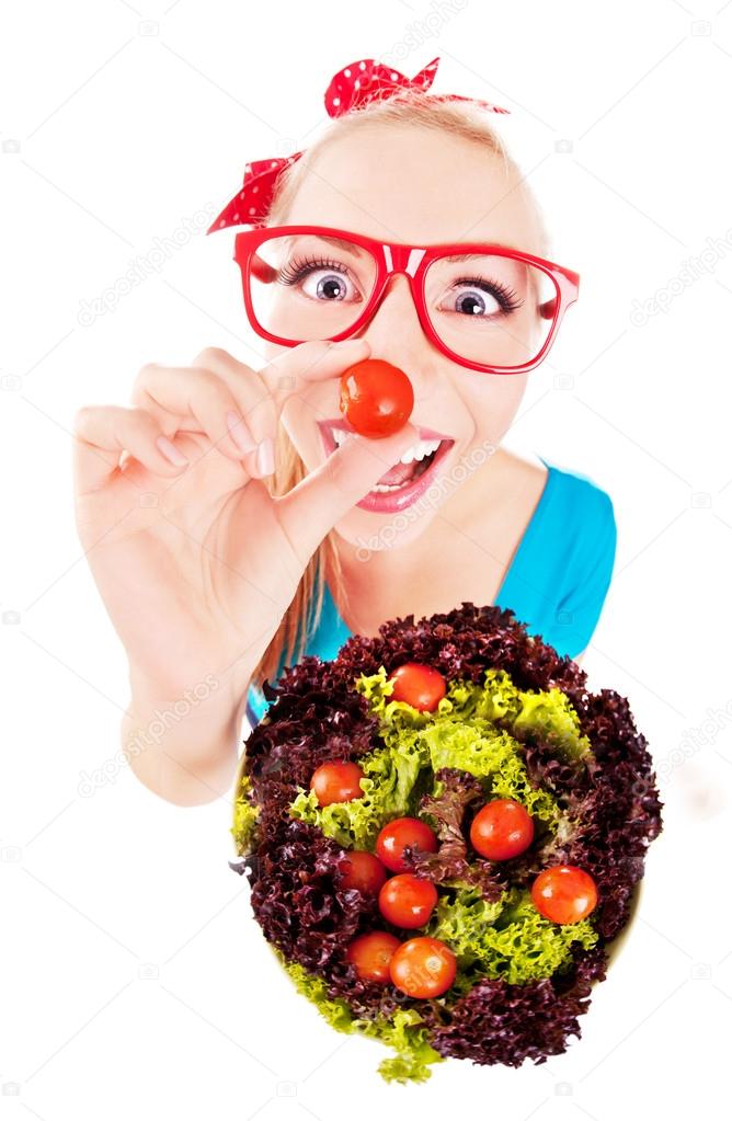Cheerful funny girl playing with salad