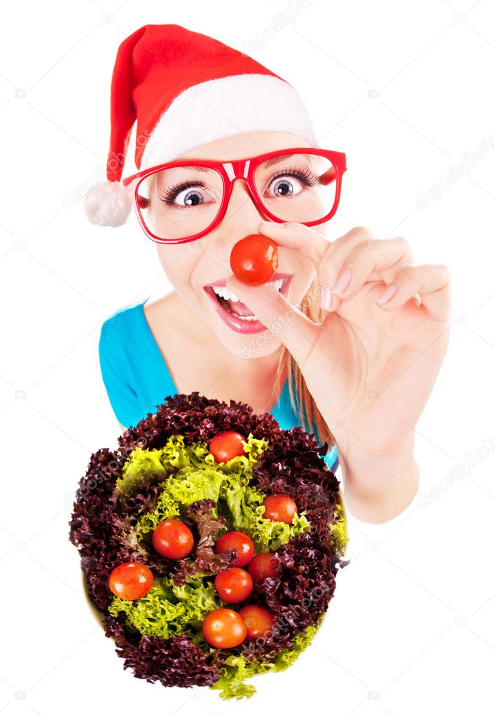 Funny santa girl playing with salad