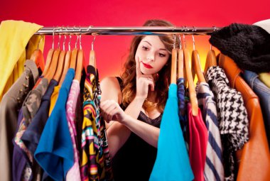 Nothing to wear concept, young woman deciding what to put on clipart