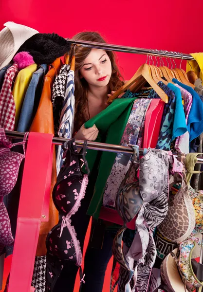 Nothing to wear concept, young woman deciding what to put on Stock Picture