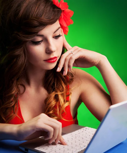 Retrato colorido de uma jovem mulher trabalhando em um laptop — Fotografia de Stock