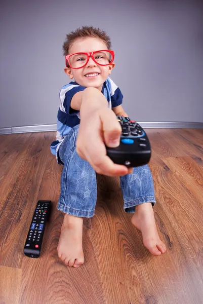 Cheerful child with tv remote control — Stock Photo, Image