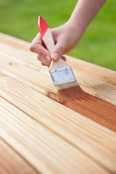 Applying protective varnish on a wooden furniture — Stock Photo, Image