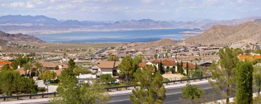 Lake Meade Bolder City Nevada suburb and mountains panorama. clipart