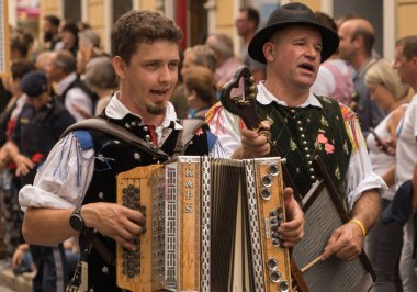 Villach, Austria - August 6, 2022: Musicians enjoy the procession of 'Villacher Kirchtag', the largest traditional folk festival in Austria, after some years of cancellation due to Covid.