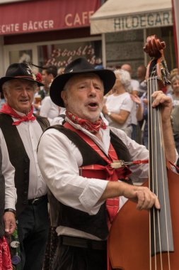 Villach, Austria - August 6, 2022: Musicians enjoy the procession of 'Villacher Kirchtag', the largest traditional folk festival in Austria, after some years of cancellation due to Covid.