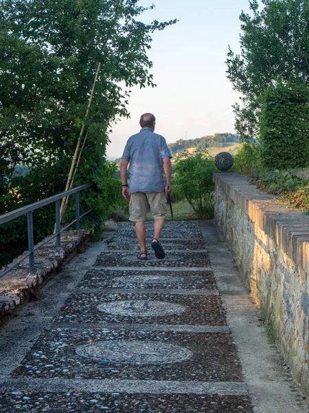 old man with sky pole walking around in garden and farm in summer season